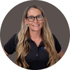 Women with long light brown and blonde hair with short sleeve black shirt on brown background