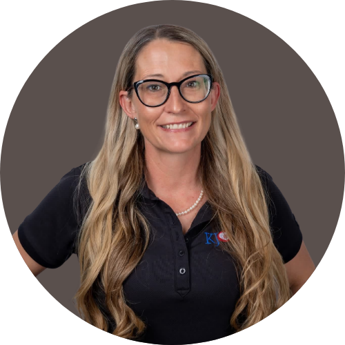 Women with long light brown and blonde hair with short sleeve black shirt on brown background