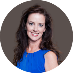 Headhsot of dark haired women with blue shirt, smiling
