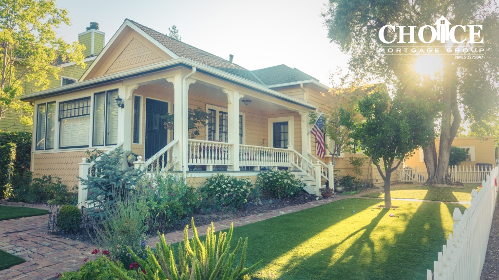 Yellow home with white pillar and green landscapaing