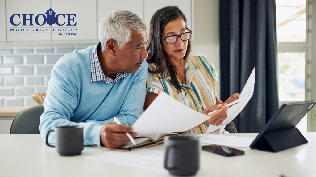 Man and woman looking at financial papers at table