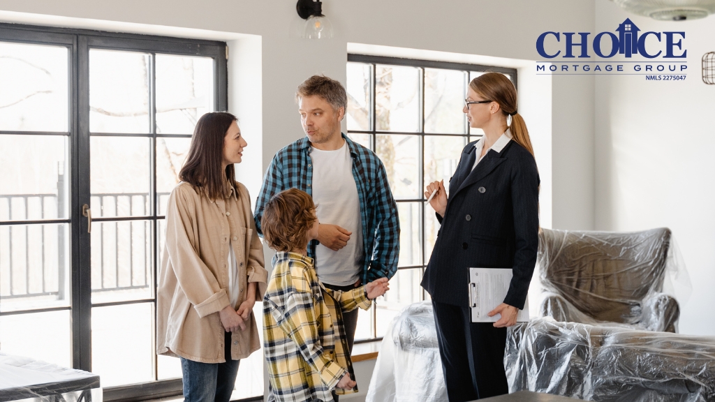 family looking at home with realtor, dark haired woman, dark haired man, young child in home with white walls and windows